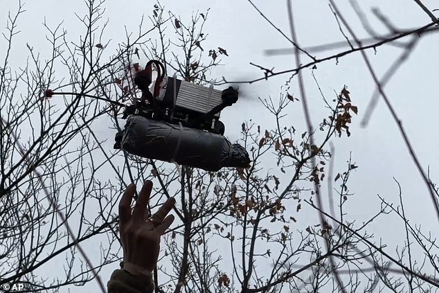 In this photo taken from a video published by the press service of the Russian Ministry of Defense on Monday, November 25, 2024, a Russian military officer launches an FPV drone towards a Ukrainian position.