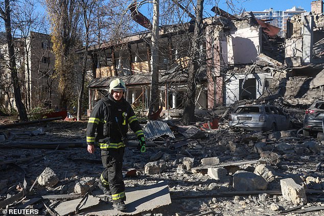 A rescuer walks in front of a building hit by a Russian missile attack, amid Russia's attack on Ukraine, in Odessa, Ukraine, on November 25, 2024.