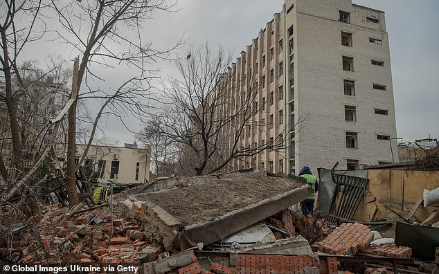 A car lies smashed under the rubble of a building destroyed by a Russian missile attack in the Kyivskyi district on November 25, 2024.