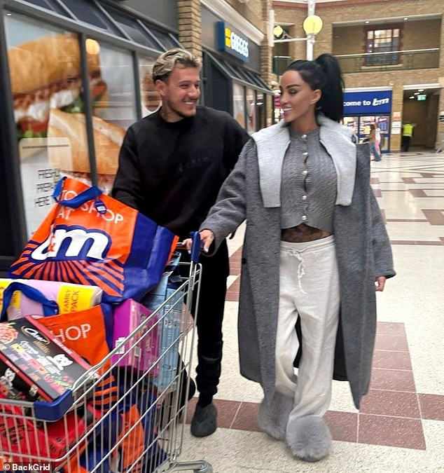 She stayed comfortable in a pair of statement fluffy platform shoes and stayed warm in a long gray wool coat.