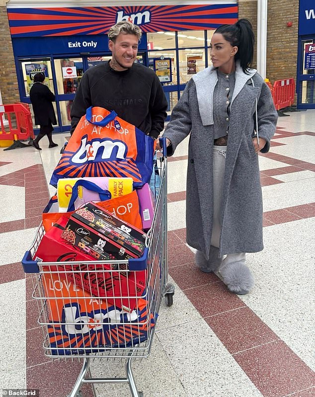 The couple were all smiles as they left B&M with five large bags of shopping loaded into their trolley.