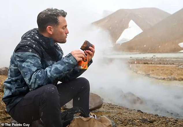 Nick eats his geothermal bread in the middle of Iceland's wild terrain