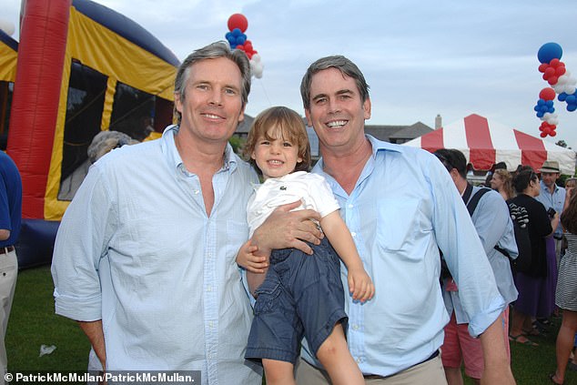 Scott Bessent is pictured next to his husband John Freeman and one of their children - Cole Bessent Freeman - in 2012