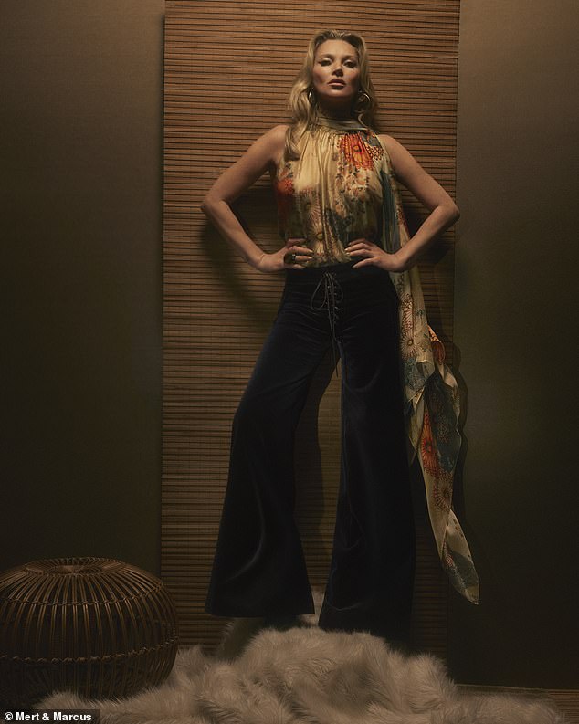 Kate Moss models her floral top and matching scarf and black pants from the Zara collection