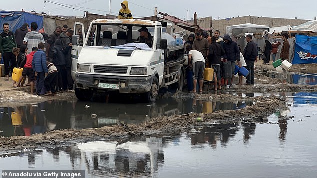 Palestinian families, forcibly displaced by the Israeli army and sheltered in tent camps, struggle due to harsh weather conditions amid continued Israeli attacks in Khan Yunis, Gaza, on November 24, 2024.