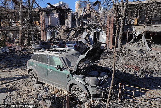 This photo taken on November 25, 2024 shows destroyed cars next to a destroyed building after a missile attack in Odessa.