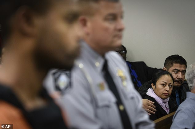 The victim's parents are seen looking at their daughter's killer during the same hearing in 2018. He will now serve life in prison without the possibility of parole.