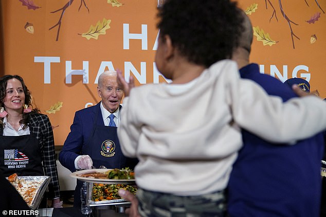 President Biden makes a face at a child while serving dinner