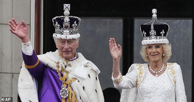 King Charles and Queen Camilla are pictured waving to the crowd at their coronation in May 2023.