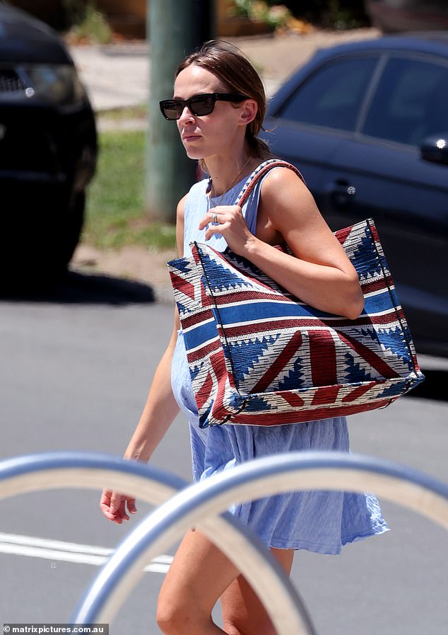 She had earlier arrived at the popular Eastern Suburbs beach wearing a loose baby blue mini dress and carrying a handbag.