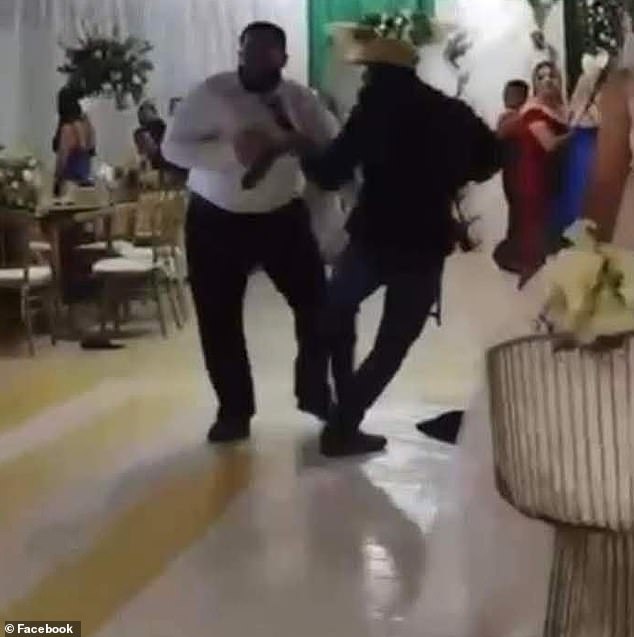 In the images you can see an armed man grabbing one of the wedding guests.