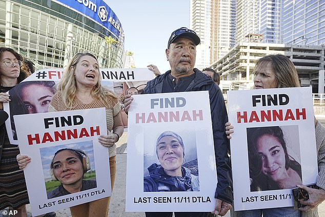 Ryan Kobayashi, center, holds a photo of his missing daughter Hannah Kobayashi outside the Crypto.com Arena, on November 21