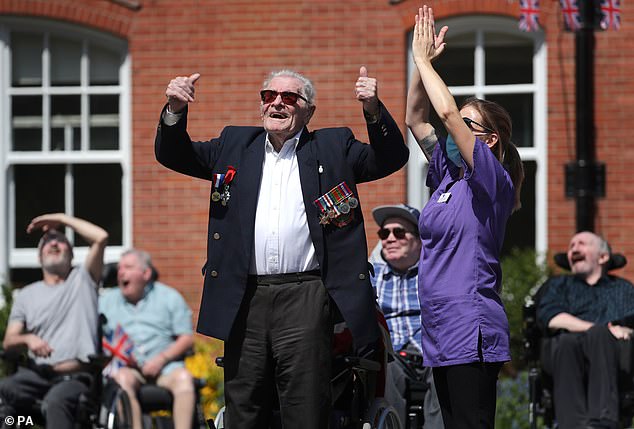 Second World War veteran Len Gibbon, 96, watches a Spitfire fly over the Care for Veterans site in Worthing, Sussex, to mark the 75th anniversary of VE Day in 2020.