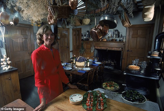 The billionaire businesswoman is no stranger to hosting a dinner party and is pictured here in the kitchen in August 1976