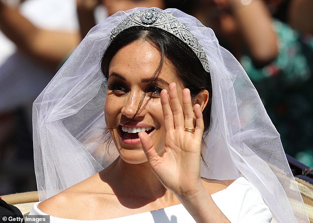 Meghan saluting with the tiara on her head at her wedding at St George's Chapel at Windsor Castle on May 19, 2018.