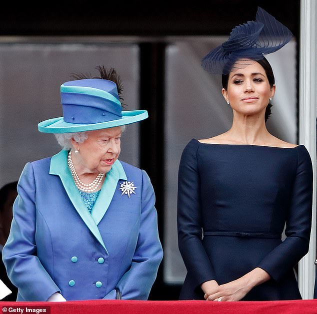 Queen Elizabeth II and Meghan watch a flyover to mark the centenary of the Royal Air Force from the balcony of Buckingham Palace on July 10, 2018.