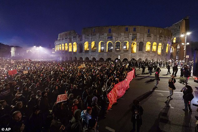 People take part in a demonstration ahead of the International Day for the Elimination of Violence against Women, in front of the Colosseum in Rome, Saturday, November 23, 2024.