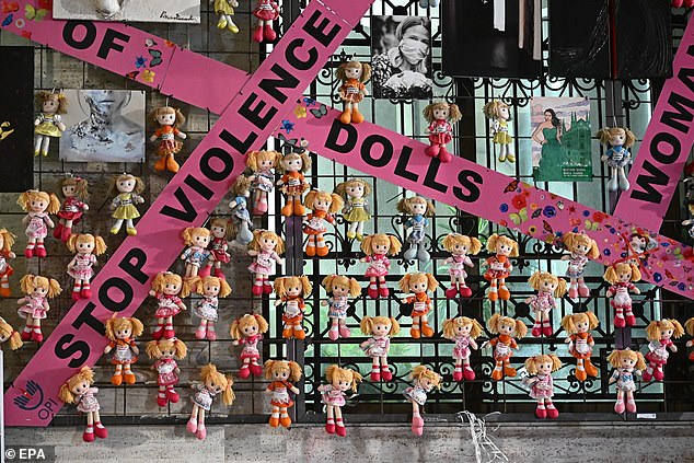 The 'Wall of Dolls' installation, commemorating victims of gender violence, is displayed on the facade of the palace in the Liguria region on the occasion of the International Day for the Elimination of Violence against Women in Genoa, Italy, on November 25, 2024.