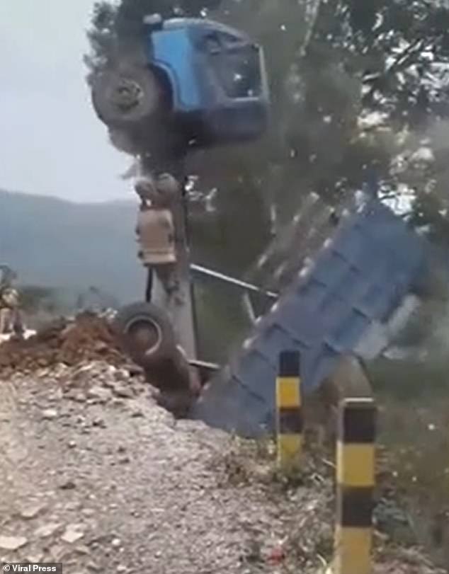 The terrifying footage shows the truck flipping completely upright, trapping the panicked driver inside, before falling completely off the edge of the cliff into the ravine.