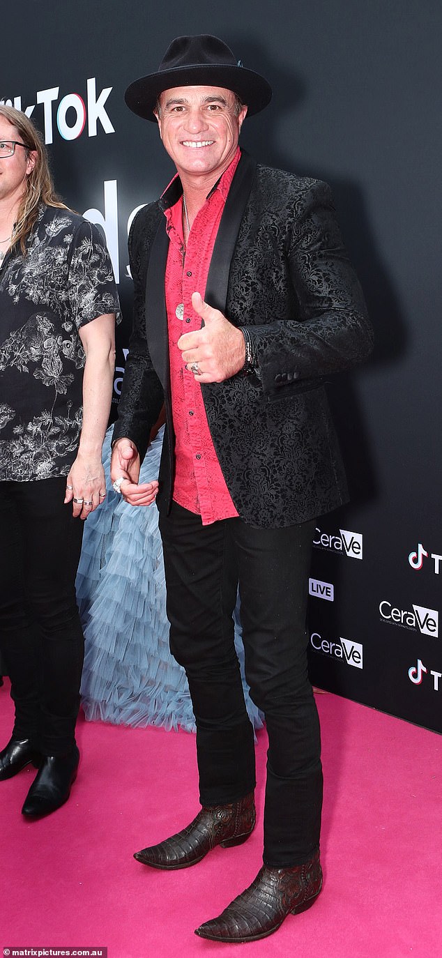 The inaugural Australian Idol runner-up, 49, looked almost unrecognizable on the event's 'pink carpet', displaying a clear air of sartorial elegance.