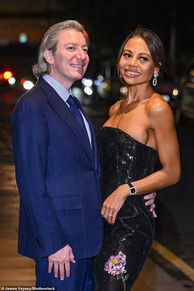 Complementing the look, she carried a small sparkly purse between a pair of red double-decker bus nails.