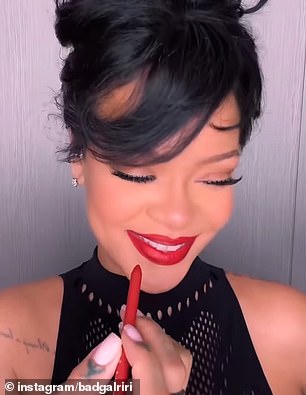 After lining her lip, Rihanna colors it.