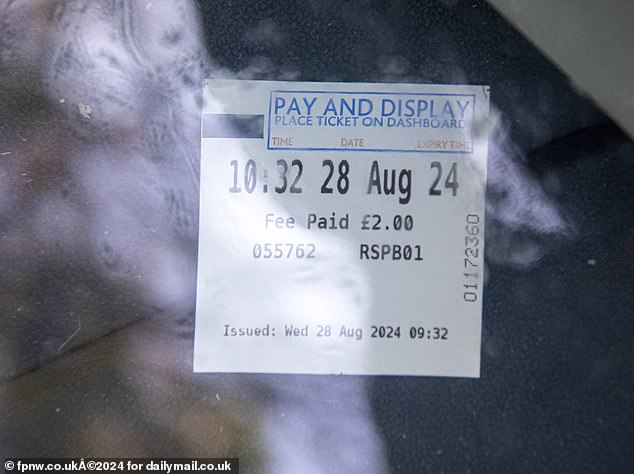 A payment and display ticket dated 28 August for a visit to an RSPB reserve can be seen in the windscreen of the car