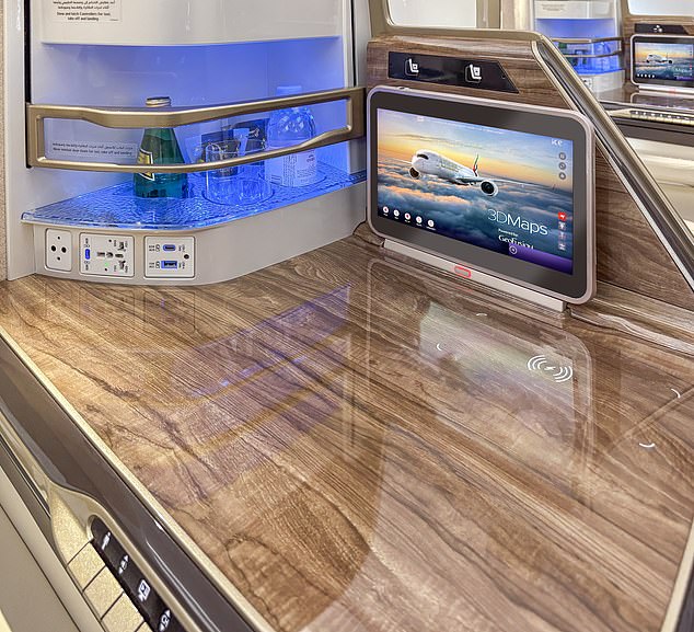 Customers in business class can use wireless charging on the side cocktail table and enjoy state-of-the-art 4K touch screens.