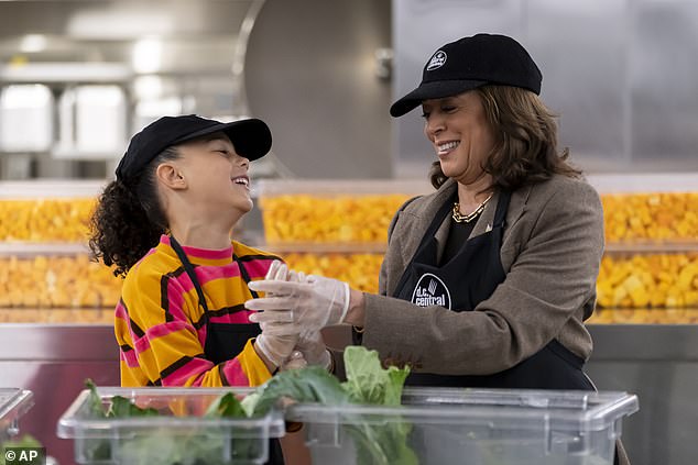 Vice President Kamala Harris (right) holds the hand of her great-niece Leela (left) as they volunteer on Thanksgiving at DC Central Kitchen