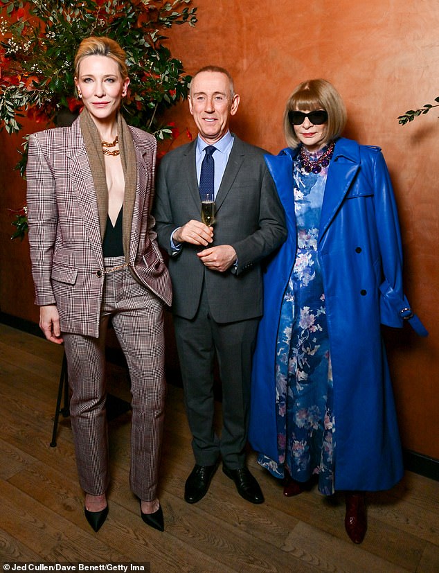 In true Vogue style, Cate posed for photos with editor-in-chief Anna Wintour, who looked chic in a blue floral dress and eye-catching oversized leather trench coat.