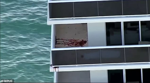 A huge bloodstain where one of the bodies was before it was removed. Blood dripped over the edge onto the lower balconies as police searched inside