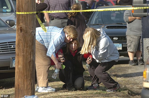 People are comforted near Sandy Hook Elementary School on Dec. 14, 2012 in Newtown