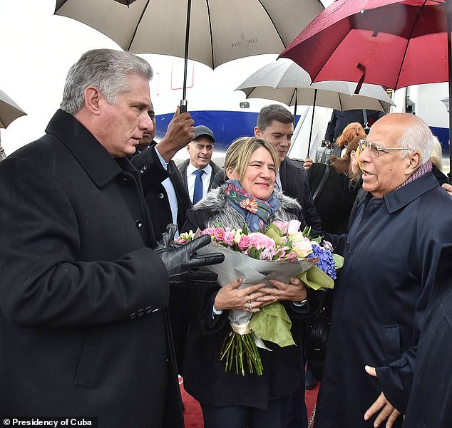 Diaz Canel, left, is seen with his wife and stepson (behind her) in Saint Petersburg, Russia in 2019