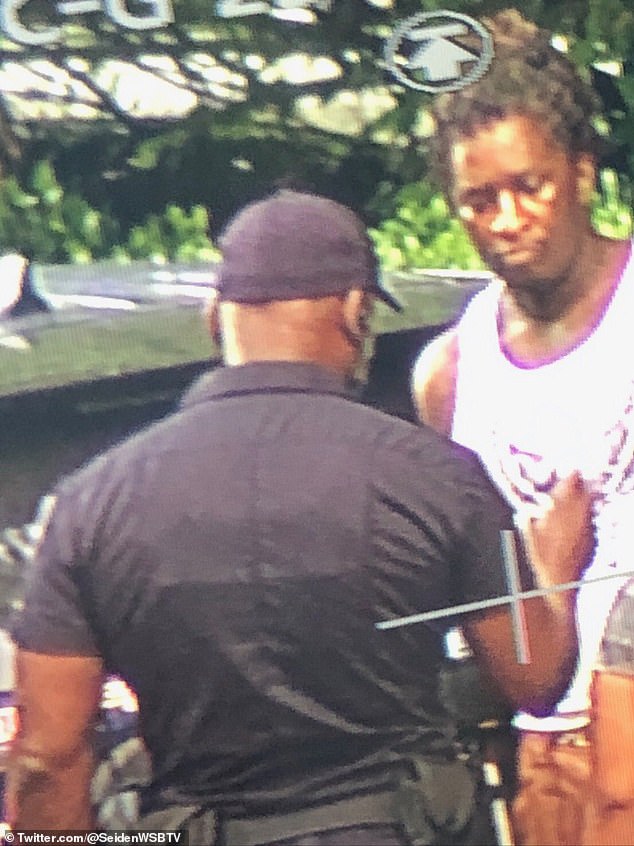 Young Thug is pictured during his arrest in the upscale Atlanta neighborhood of Buckhead.