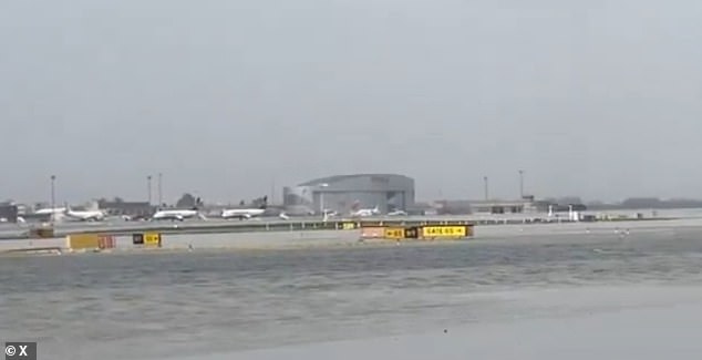 Flooding is seen on the runway at Barcelona's El Prat airport, with flight diversions