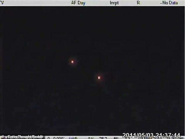 Many Reddit users initially thought the dots were flares, but then the camera switches from FLIR mode to normal vision, revealing that the orbs were bright dots of various colors that moved rigidly in a spatial relationship with each other.