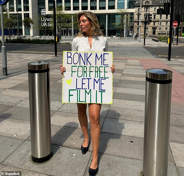 Bonnie Blue is pictured holding a sign that says 