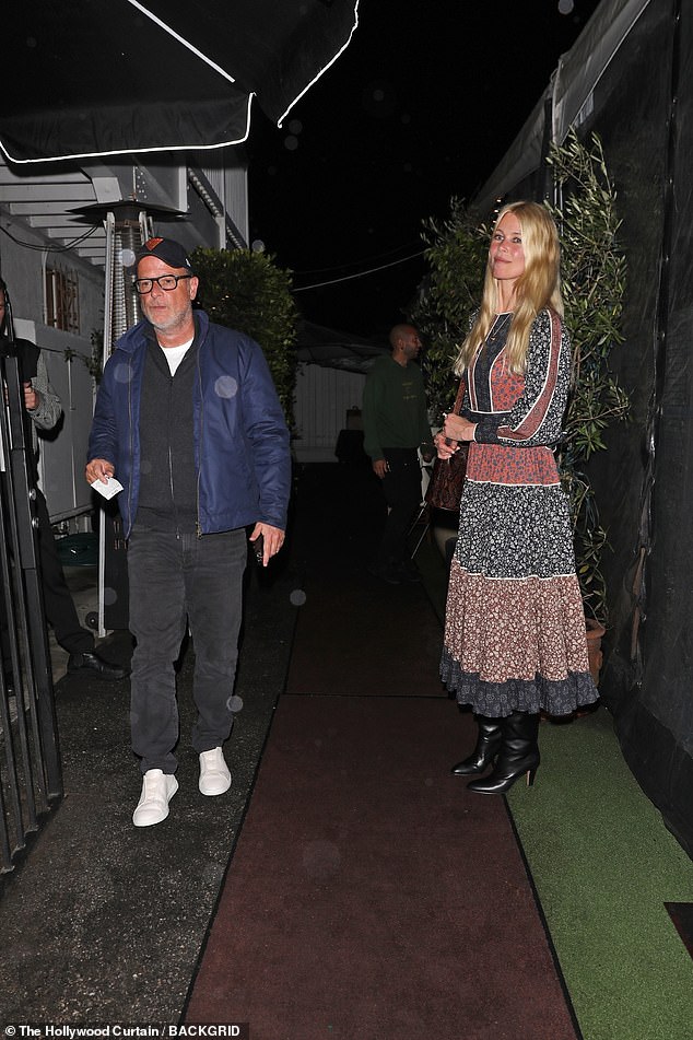 The supermodel, 54, wore a boho-inspired blue and red midi dress with black boots while photographer leaving the restaurant with her husband.