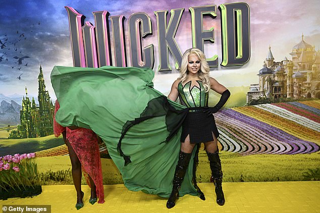 Her large green cape caused some problems for other Australian celebrities who were clamoring for their turn on the media wall at the end of the carpet. Pictured: Courtney Act and her cape, and Suzan Mutesi.