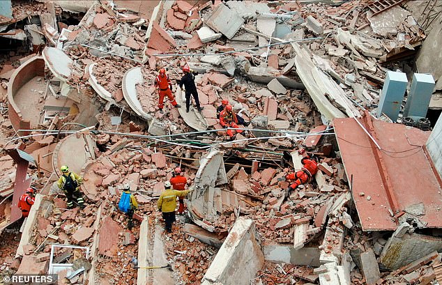 A drone view shows rescuers searching for victims in the rubble of the Dubrovnik hotel after its collapse on October 29.