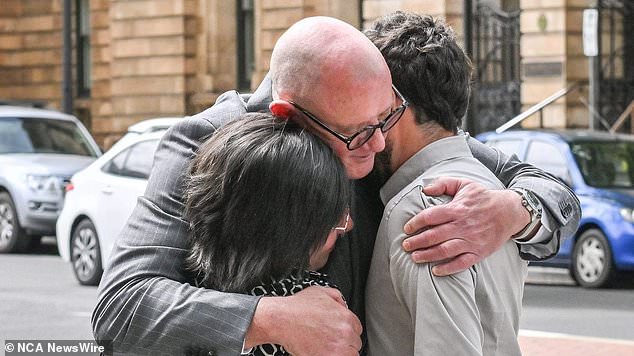 Perrone and Cairo hug their lawyer Michael Woods after Friday's sentencing