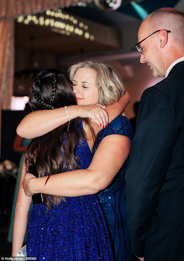 Audrey Tyrrell sincerely hugging her mother Tracey and father Andrew Tyrrell