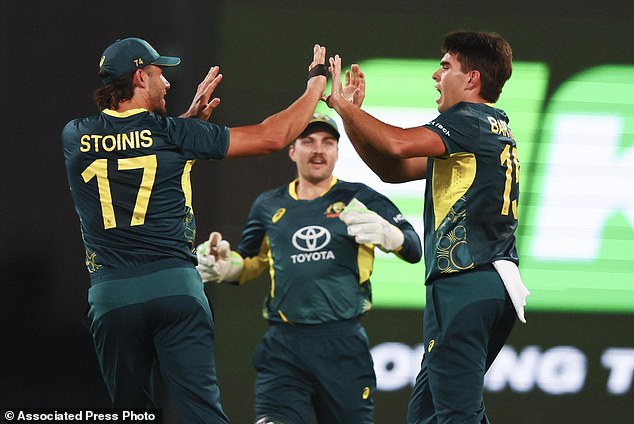 Australia's Xavier Bartlett, right, is congratulated by teammate Marcus Stoinis, left, after dismissing Pakistan's Mohammad Rizwan during the T20 international cricket match between Pakistan and Australia at the Gabba in Brisbane, Australia, on Thursday, November 14, 2024. (AP Photo/Tertius Pickard)