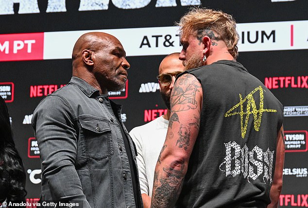 Tyson and Paul step on the scale before their meeting in the ring at AT&T Stadium