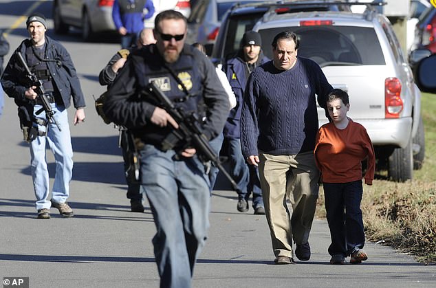 In this Dec. 14, 2012, file photo, parents leave a staging area after reuniting with their children following a shooting at Sandy Hook Elementary School in Newtown.