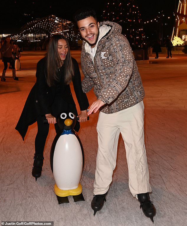 Showing off their beginner ice skating skills, the pair were seen trying to cross the rink with the help of a penguin.