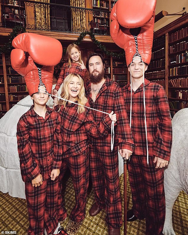 Kate, her sons and daughter posed with Danny with his two children wearing giant boxing gloves on their heads.