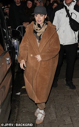 Lily bundled up in an oversized teddy bear coat and a scarf which she layered over a brown tracksuit.