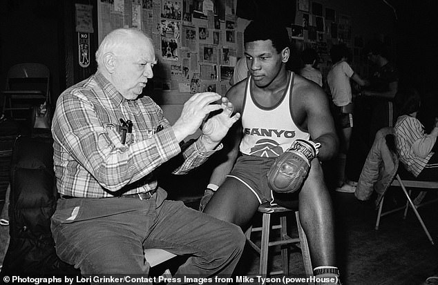 Boxing trainer Cus D'Amato transformed young Mike Tyson (pictured together) into a boxing phenomenon.