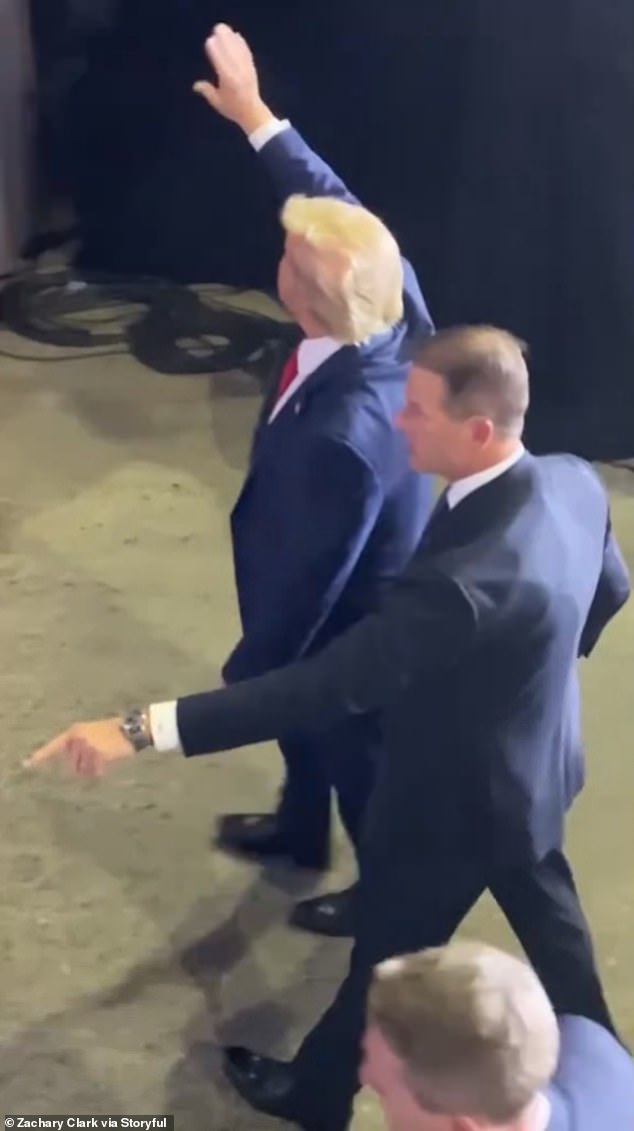 A member of the secret service reacted quickly by kicking the phone and pointing it at him.